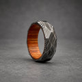 Damascus Steel Wedding Band — Hammered Whiskey Barrel Wood Sleeve