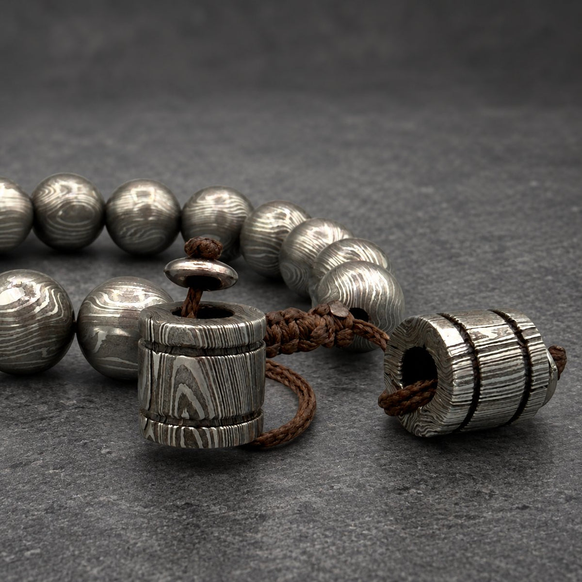Close-up of Damascus steel Norse cuff beads showing individual grain pattern