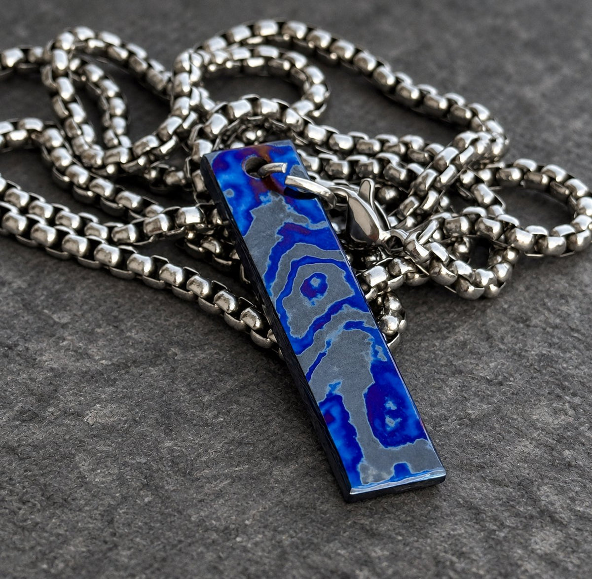 Close-up of Timascus dogtag showing colored oxide layer boundaries