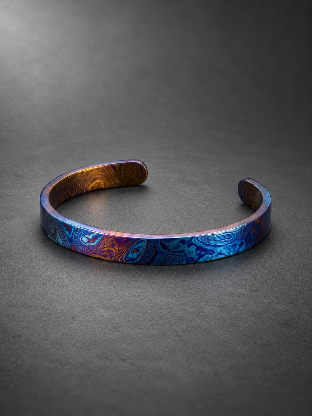 Close-up of Timascus mokume gane pattern showing layered titanium oxide coloring