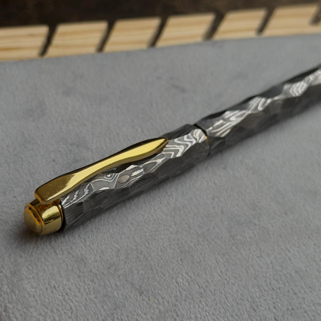 Damascus steel fountain pen shown disassembled showing cap and barrel