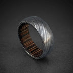 Damascus steel domed ring with dark wood inlay, side view