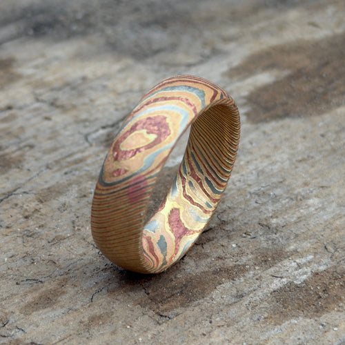 Mokume gane wedding band side view, unique layered copper brass pattern