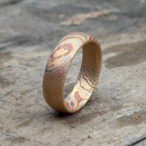 Mokume gane ring photographed at an angle showing surfaced sheet pattern