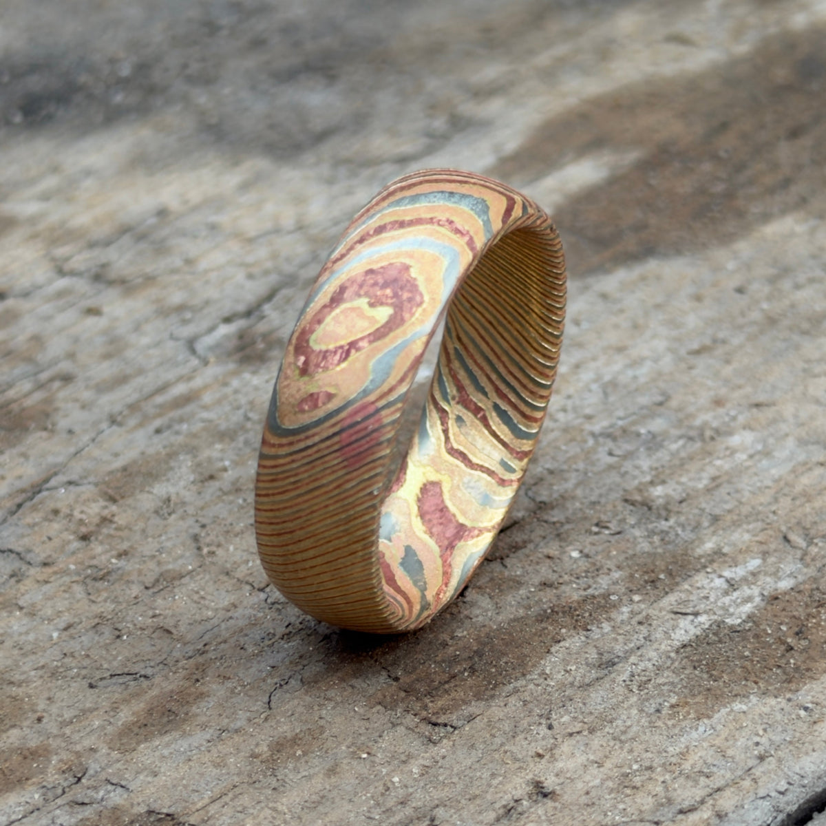 Personalized acid etched mokume gane wedding band with engraved interior