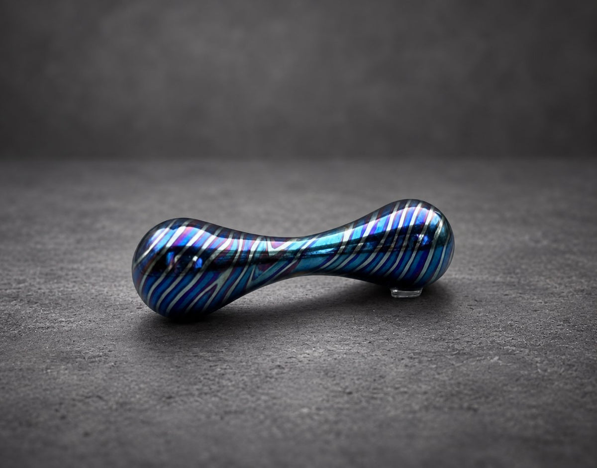 Close-up of polished titanium knucklebone fidget showing waisted bar shape
