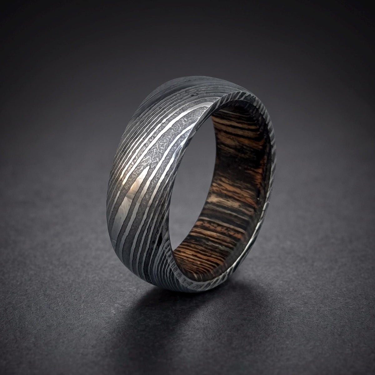 Damascus steel domed wedding band with dark wood inlay, 6mm ring