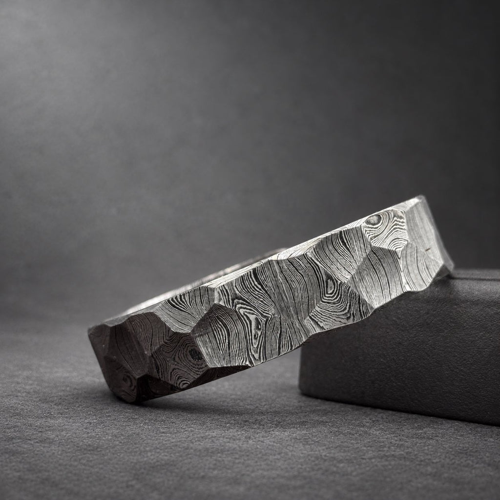 Close-up of hammered Damascus steel bracelet showing shallow dent texture