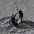 Close-up of black ceramic oxide finish on hand-forged zirconium band