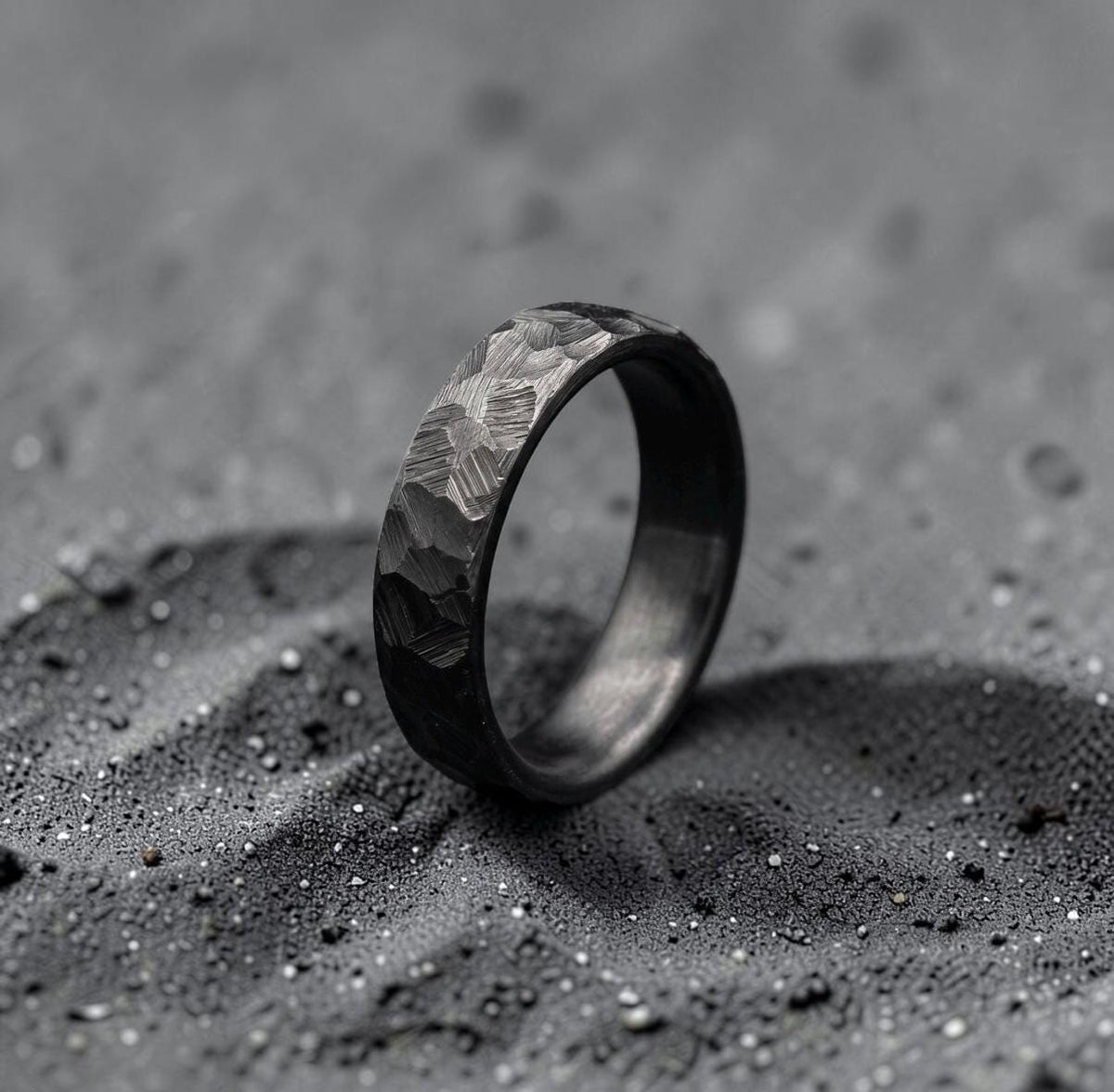 Close-up of black ceramic oxide finish on hand-forged zirconium band