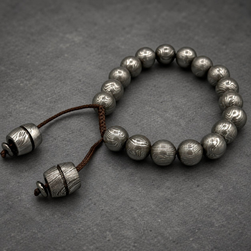 Damascus steel beaded bracelet worn on wrist, adjustable Viking cuff