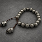 Damascus steel beaded bracelet worn on wrist, adjustable Viking cuff