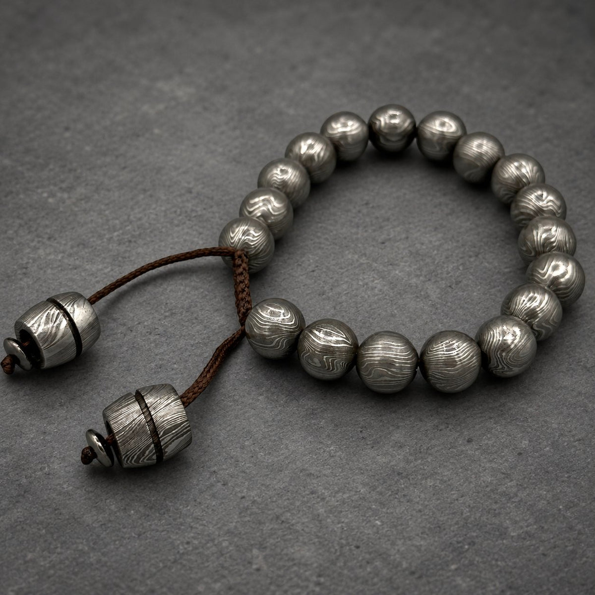 Damascus steel beaded bracelet worn on wrist, adjustable Viking cuff
