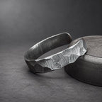 Damascus steel cuff bracelet worn on wrist, hammered Viking bangle