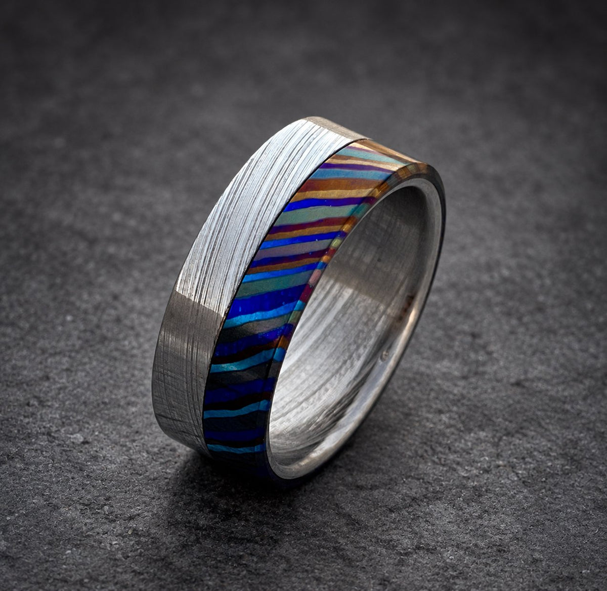 Close-up of Zircoti black and color titanium layered pattern on wedding band