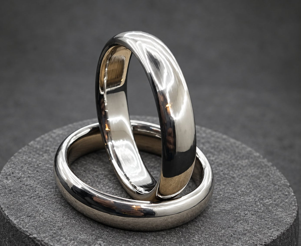 Two silver wedding bands stacked on top of each other. The bands are smooth and shiny, view 5