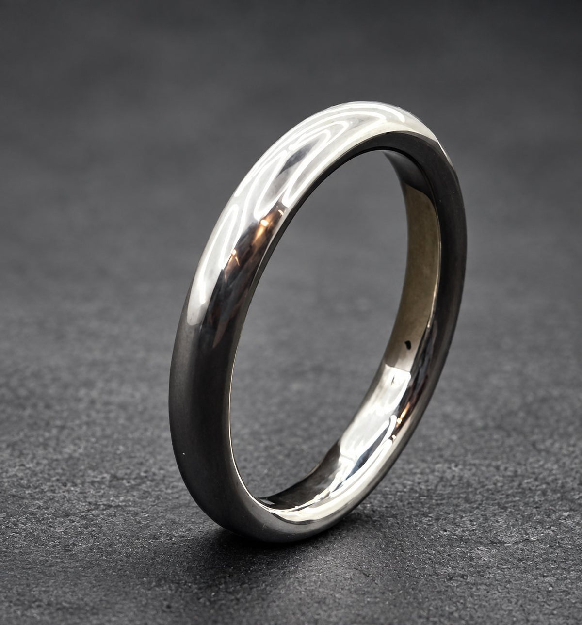 A simple silver wedding band with a brushed finish.