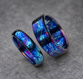 Two rings with a blue, purple and white swirling pattern. The rings are made of metal and have a polished finish.