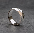 A silver ring with a faceted, geometric design. The ring is made of metal and has a brushed finish, view 5
