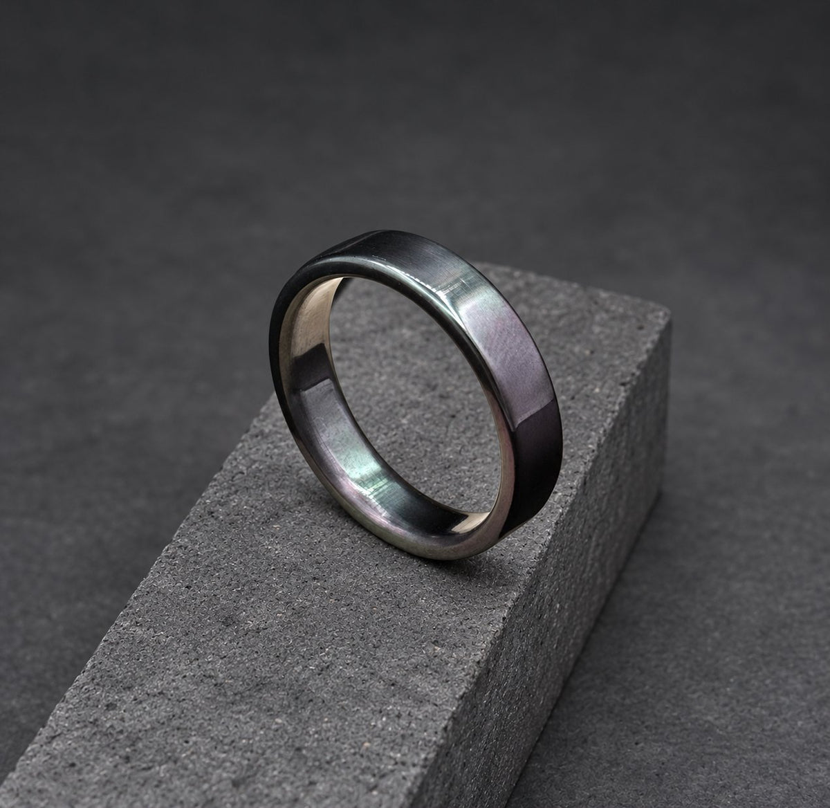 A black ring with a slightly rounded edge. The ring is made of metal and has a matte finish.