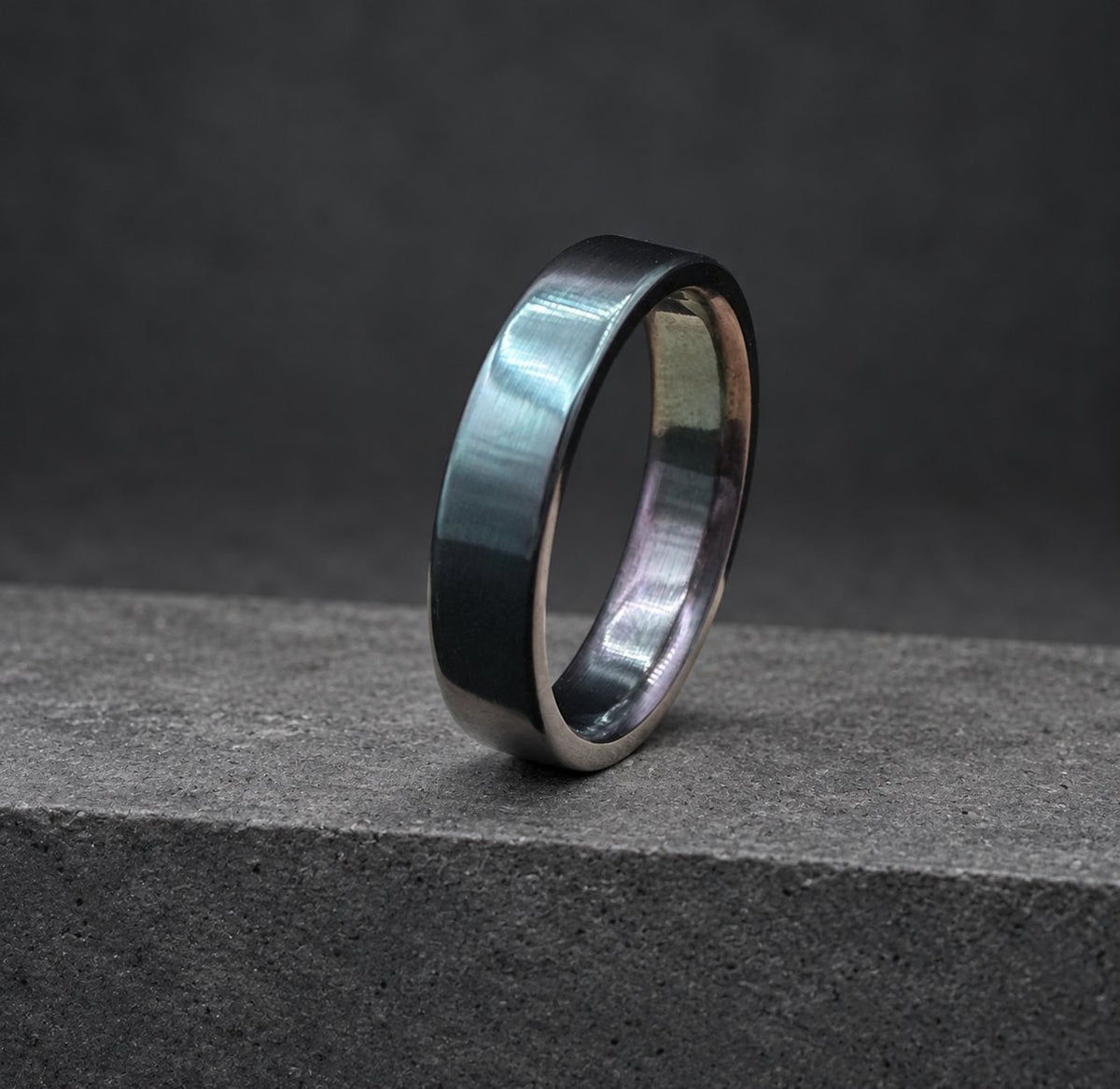 A black metal ring with a brushed finish.