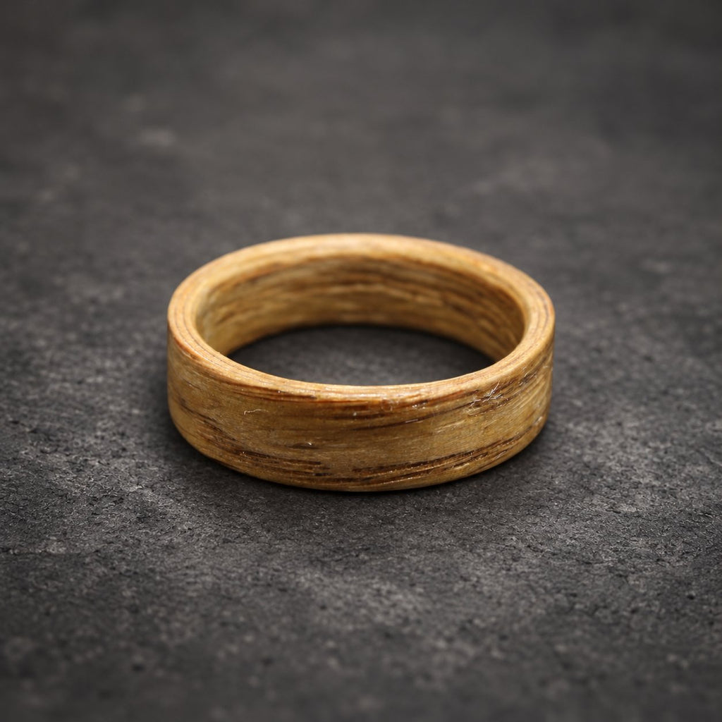 A wooden ring with a light brown color and a natural wood grain pattern.