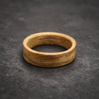 A wooden ring with a light brown color and a natural wood grain pattern.