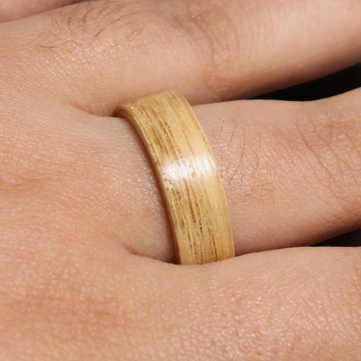 A light brown wooden ring with a smooth, polished finish.