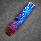 A striking bottle opener with a distinctive design. The opener showcases a blue and white pattern, reminiscent of lightning, blending into orange and purple tones. It has a hole at the top for hanging, with a length of approximately 10 cm.