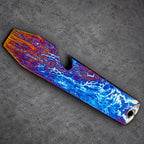A striking bottle opener with a distinctive color scheme. The opener displays a pattern of orange, blue, and purple, reminiscent of a stormy sky. It includes a bottle cap opener and a small hole.