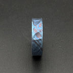 A blue and purple ring with a distinctive pattern. The ring features a dark blue base with swirling patterns of lighter blue, purple, and touches of orange. The ring is a band style.