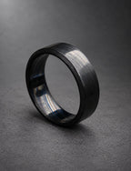 Black Damasteel band standing on its edge