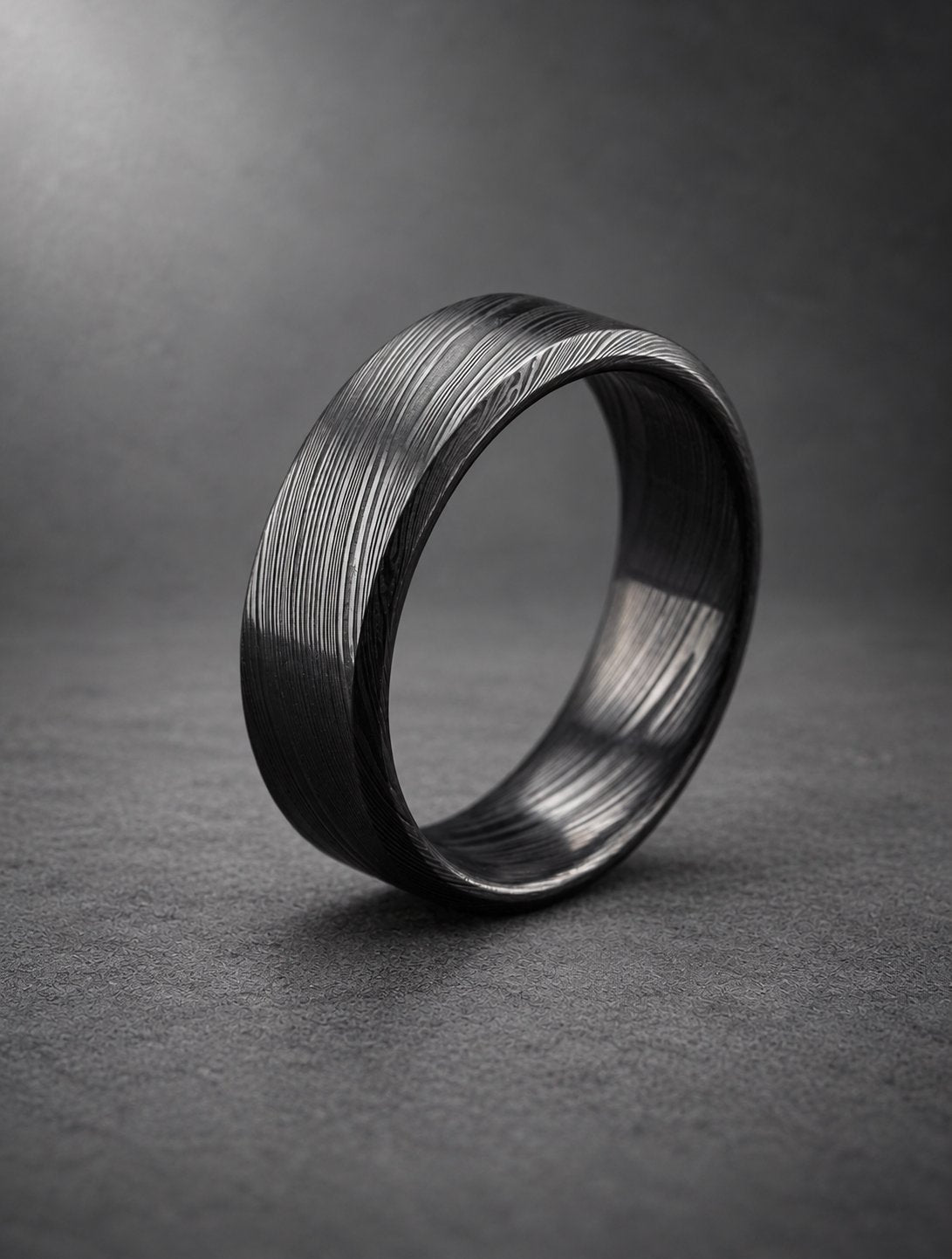 Black beveled Damasteel band, three-quarter view