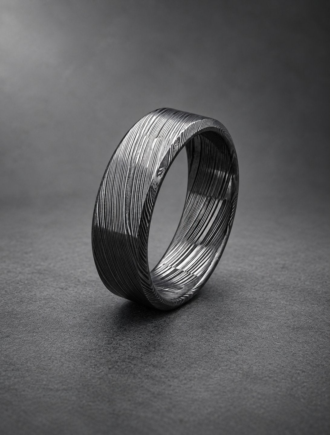 Damasteel wedding band, the layered pattern showing through the black finish