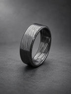 Damasteel wedding band, the layered pattern showing through the black finish